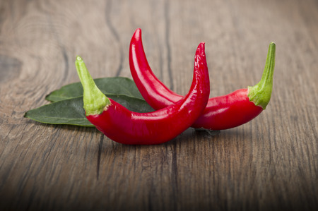 Red chili pepper isolated on a wood backgroundの写真素材