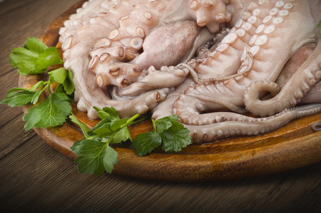 fresh octopus with potatoes and parsley on woodの写真素材