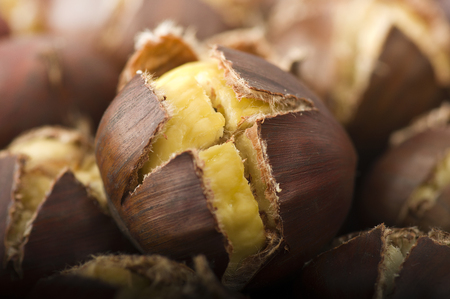 group of chestnuts on a wooden tableの写真素材