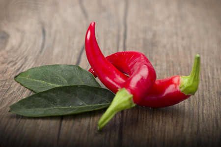 Red chili pepper isolated on a wood backgroundの写真素材