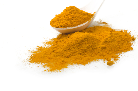 dust of ground turmeric on the spoonの写真素材