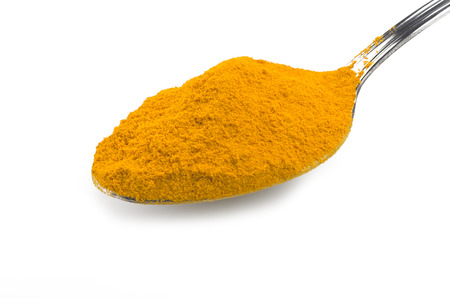 dust of ground turmeric on the spoon の写真素材