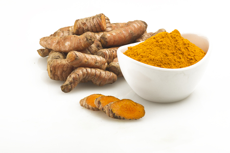 turmeric root and some slices on a white background の写真素材