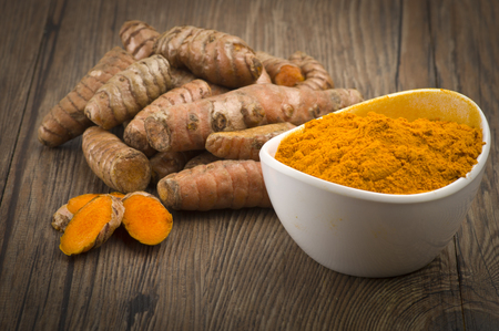 dust of ground turmeric on the wood backgroundの写真素材