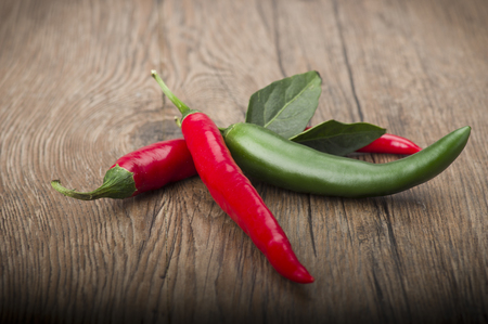 Red chili pepper isolated on a wood backgroundの写真素材