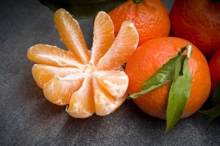 Ripe orange tangerine clove on the gray tableの写真素材