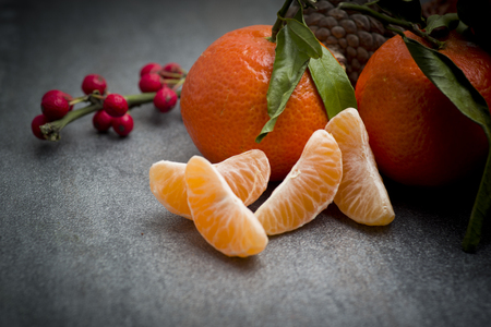 Ripe orange tangerine clove on the gray tableの写真素材