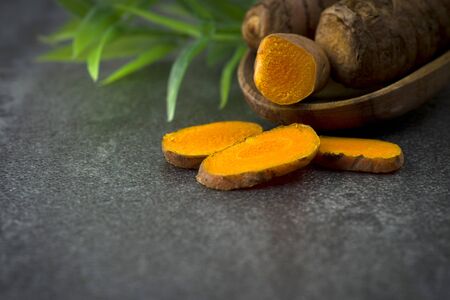 turmeric slices close up on gray background 