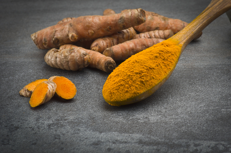 dust of ground turmeric on the grey backgroundの写真素材