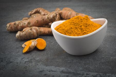 dust of ground turmeric on the grey backgroundの写真素材