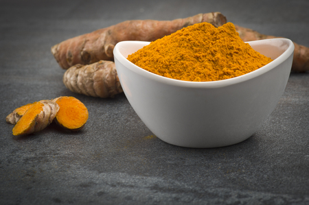 dust of ground turmeric on the grey backgroundの写真素材