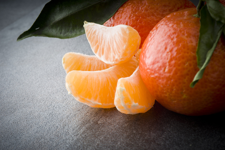 Ripe orange tangerine clove on the gray tableの写真素材