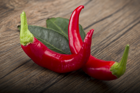 Red chili pepper isolated on a wood backgroundの写真素材
