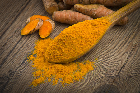 dust of ground turmeric on the wood backgroundの写真素材