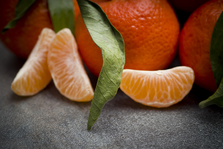 Ripe orange tangerine clove on the gray tableの写真素材