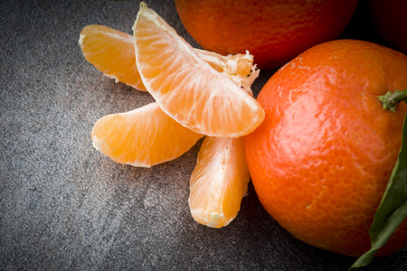 Ripe orange tangerine clove on the gray tableの写真素材