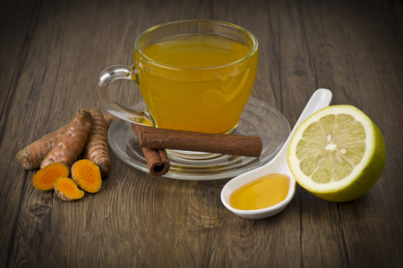 herbal tea with turmeric powder,slices and cinnamonの写真素材