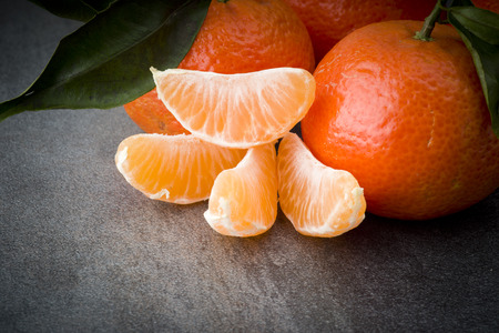 Ripe orange tangerine clove on the gray tableの写真素材