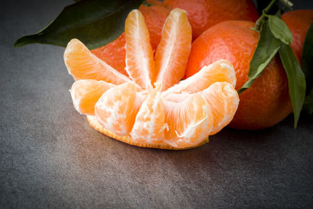 Ripe orange tangerine clove on the gray tableの写真素材