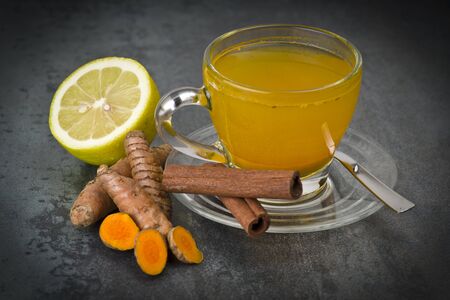 herbal tea with turmeric powder,slices and cinnamonの写真素材