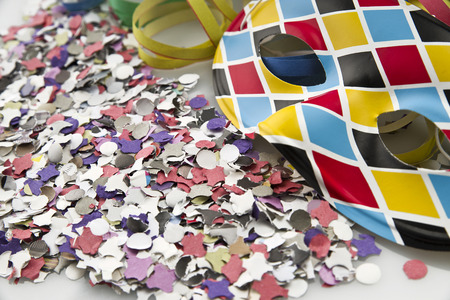 Carnival mask on colorful confetti and streamer backgroundの写真素材