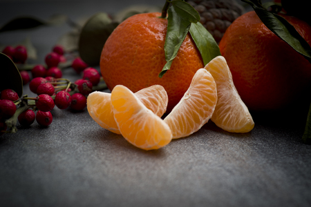 Ripe orange tangerine clove on the gray tableの写真素材