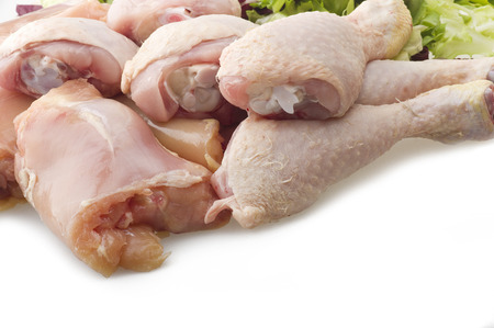 Fresh skinless chicken thighs and legs on the whiteの写真素材