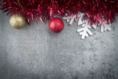 Christmas background with decorations and gift boxes on grey boardの写真素材