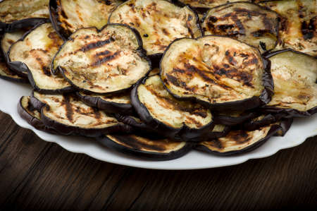 Aubergines eggplants and slices grilled on the plateの写真素材