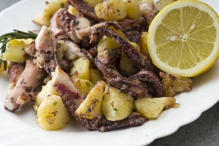 octopus salad with potatoes in a dishの写真素材
