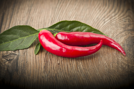Red chili pepper isolated on a wood backgroundの写真素材