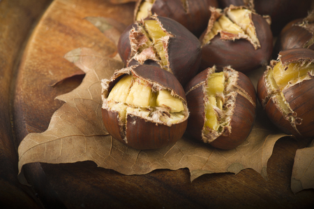 group of chestnuts on a wooden tableの写真素材