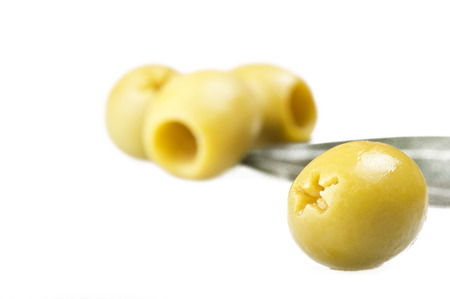 Pitted green olives close up on the white の写真素材