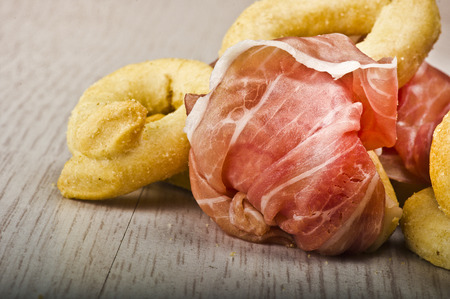 Taralli on the white wood table with sliced hamの写真素材