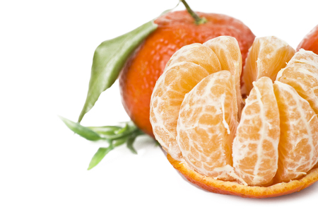 Mandarin or Tangerine fruit with leaves on a white backgroundの写真素材