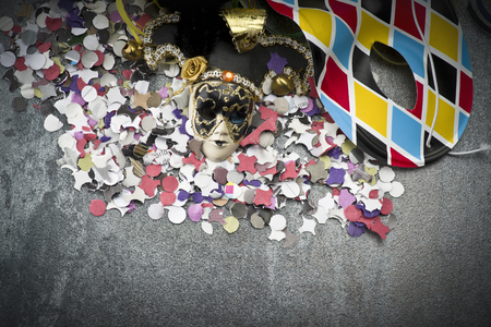 Carnival mask on colorful confetti and streamer backgroundの写真素材