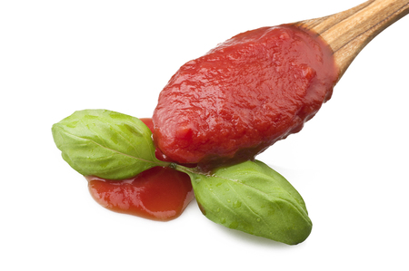 wooden spoon with tomato sauce and basilの写真素材