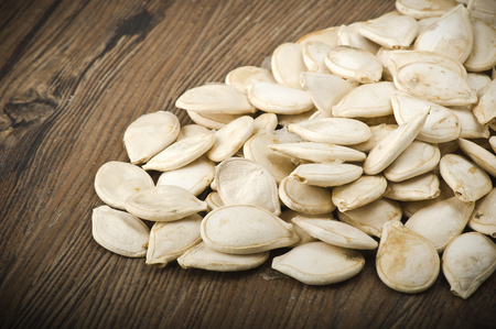 Dried pumpkin seeds on the wood tableの写真素材