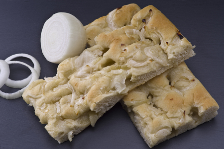 white pizza with onions on the slate stone backgroundの写真素材