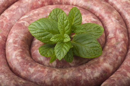 pork sausage rolled up on the cutting boardの写真素材