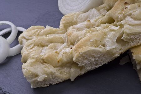 white pizza with onions on the slate stone backgroundの写真素材