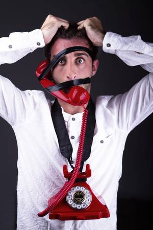 A hysterical man with the phone tied to the face