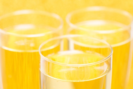 Champagne flutes for a special day with golden backgroundの写真素材