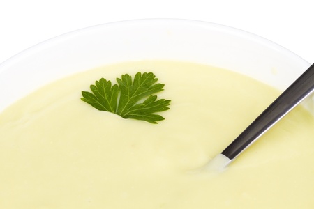 cream soup of courgette in white bowl isolatedの写真素材
