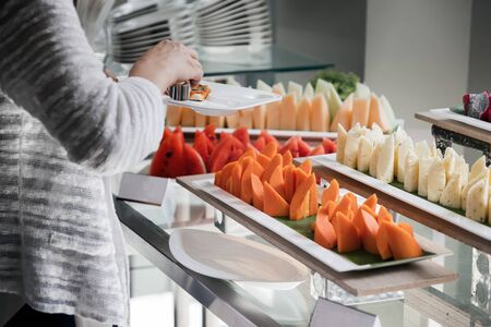 a people pickup some fruit for lunchの写真素材