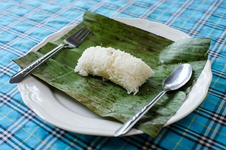steamed rice with banana leaf spoon and folk on a dish