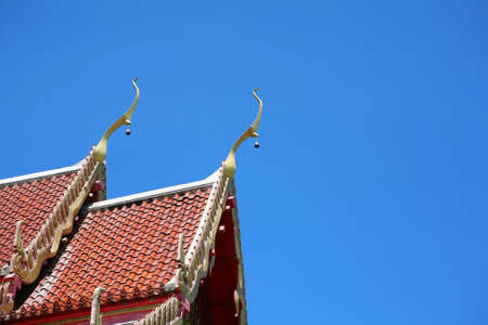 Thai temple roof in clear blue skyの写真素材