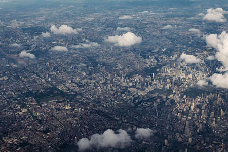 Bangkok city's bird eye view shot from a plane that flight in a morning with warming color of...