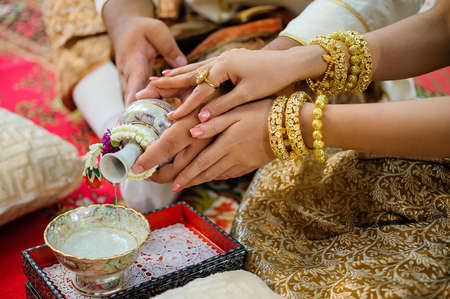 pouring holy water in thai weddingの写真素材