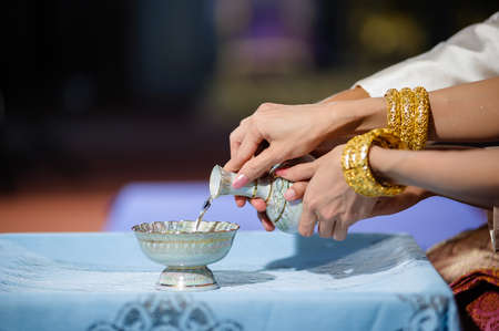 pouring holy water in thai wedding